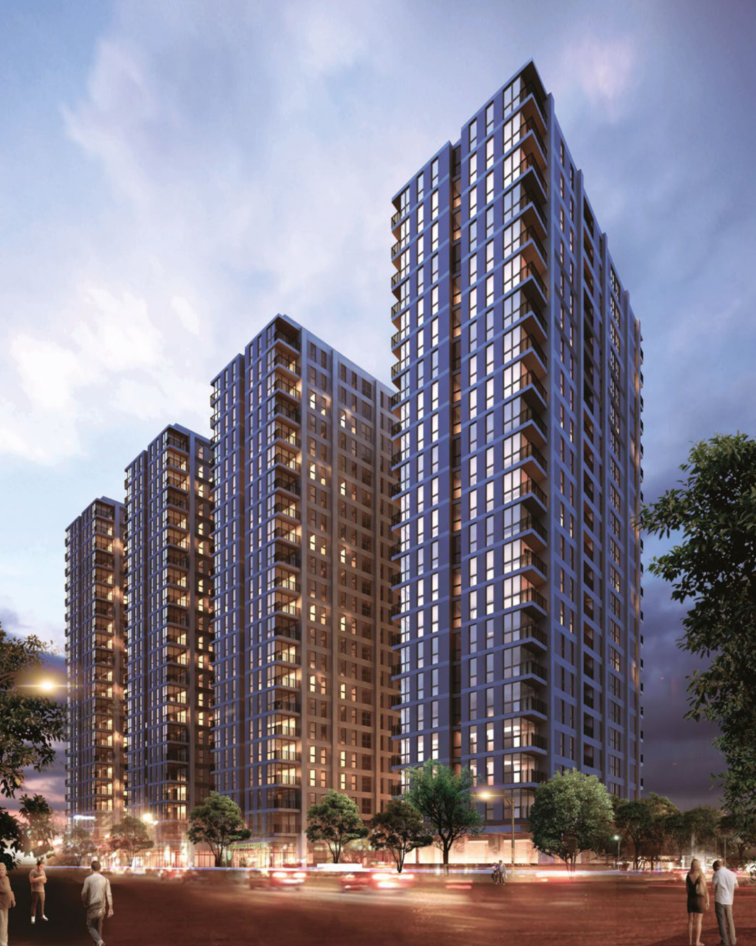 Inclusiv: conjunto de torres de vivienda vertical iluminadas al anochecer