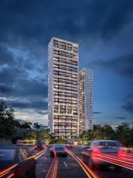 Origina Santa Fe: torre residencial iluminada al anochecer sobre la avenida